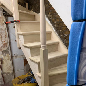 Carpentry contractors working on a staircase for a national home building company in Hertfordshire.